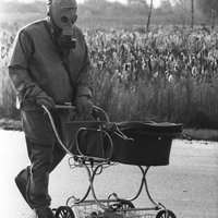 Človek, ktorý meral rádioaktivitu v Černobyle, tlačí v kočári mŕtve dieťa, ktoré našiel v opustenej budove. 1986